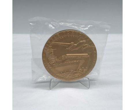 The obverse side depicts the North American B-25B Mitchell launching off the USS Hornet, CV-8. 16 stars representing the 16 f