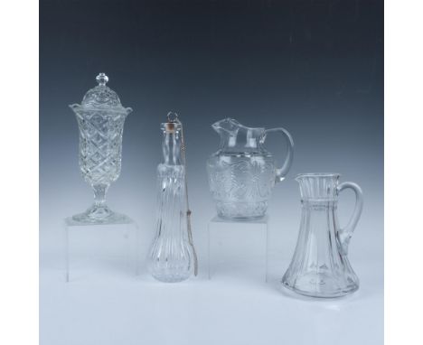 The grouping includes an ice lipped pitcher, a wide bottom pitcher, a covered tall dish with SM on the lid, and tall lidded d