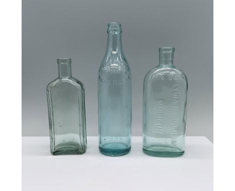 A set of three blue-tinted glass bottles including a round one labeled Niagara Beverage Corporation Niagara Falls N.Y., an ov