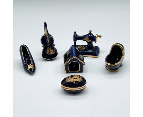 Delicate group of figures colored in deep blue with gilt accents. Collection includes cello; high heel shoe; egg; baby bed; s