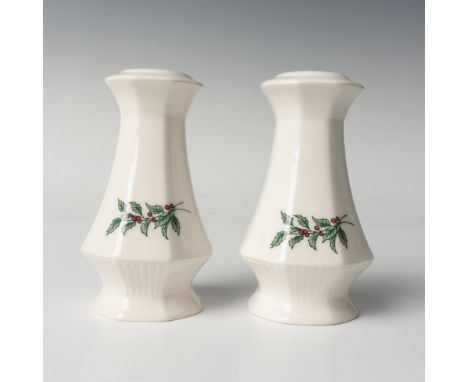 A set of 2 white table shakers decorated with illustrations of a holly branch. JAPAN stamped in green on the bottoms. This it