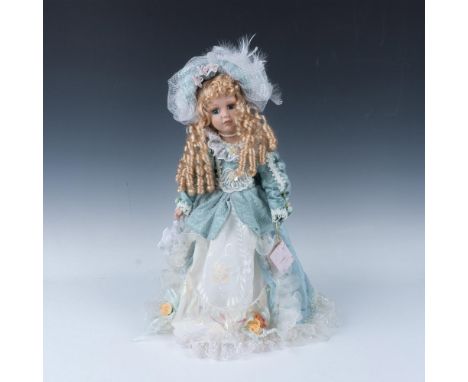 Hand crafted and hand painted doll dressed in hand sewn dress of turquoise satin and lace with matching hat. Blond long curls