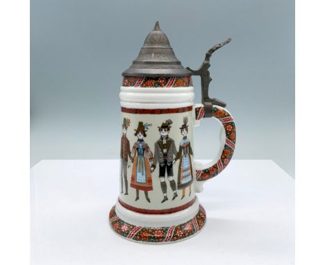 A whimsical Germany folk art style mug with a pewter covered lid. The impressed image a the interior bottom of the mug depict