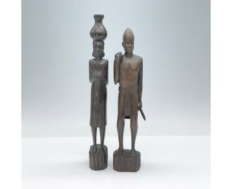 These two hand-carved figurines depict the man as a warrior or hunter, holding spears in his hands, while the woman is portra