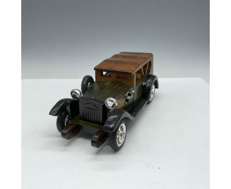 Wooden model car colored in natural, green and black with silver toned lights, handles and wheels. This item has its original