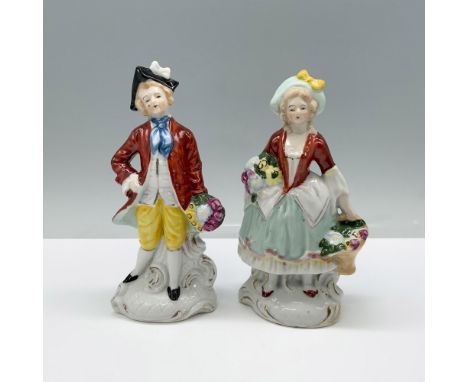 A man dressed in vibrant red, yellow, white, and blue, holding a bouquet of flowers, and a woman in red, mint, and white, cra