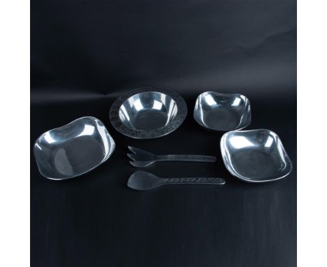 3 pieces from the Reggae collection featuring zigzag and spiral artwork: a serving spoon, serving fork, and bowl. The other 3
