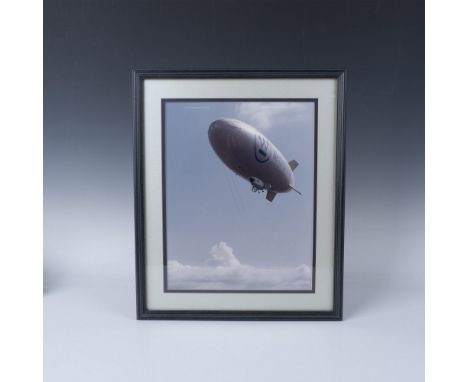 Large original glossy photograph of the Sentinel 1000 Westinghouse airship flying above the clouds. Housed in a black frame w