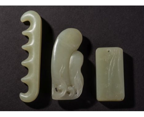 A Chinese celadon jade carved pendant: carved to one side with bamboo shoots, 5.5cm long, a celadon jade five-division brush 