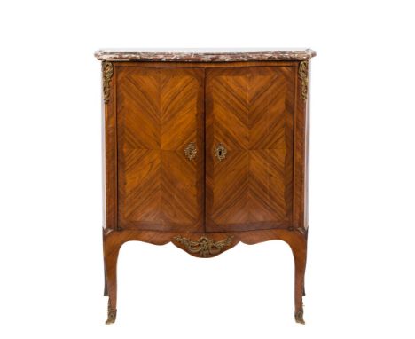 A late 19th Century French kingwood, crossbanded and inlaid gilt metal mounted serpentine fronted petit commode:, surmounted 