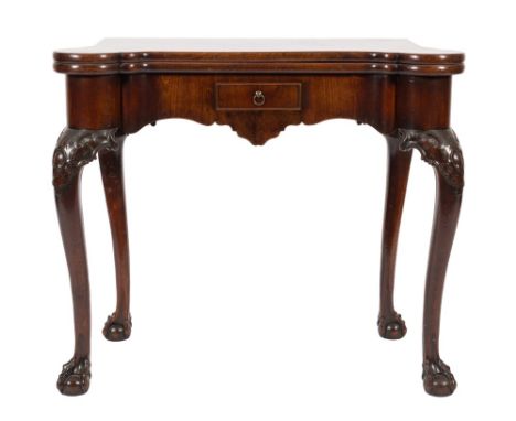 A George II carved mahogany card table:, of Chippendale design, the hinged top of shaped outline enclosing a baize lined inte