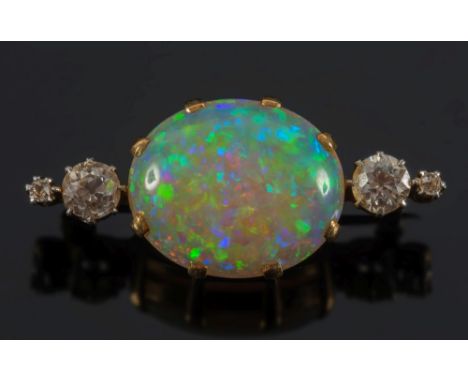 A gold, opal and diamond bar brooch: with central oval opal approximately 19mm x 15.5mm, claw-set between round old brilliant