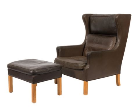 An Art Deco style beechwood frame wing armchair and matching stool:, fully upholstered in leather on square section legs.