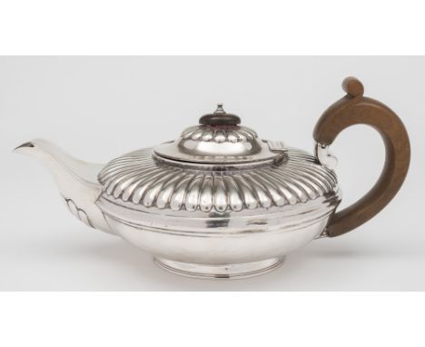 A George IV silver teapot, no maker's mark, London 1829:, of squat melon shape with half reeded decoration on a circular foot