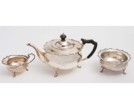 A George V silver three-piece tea service, maker Henry Atkin, Sheffield, 1914:  of squat circular form with piecrust borders,