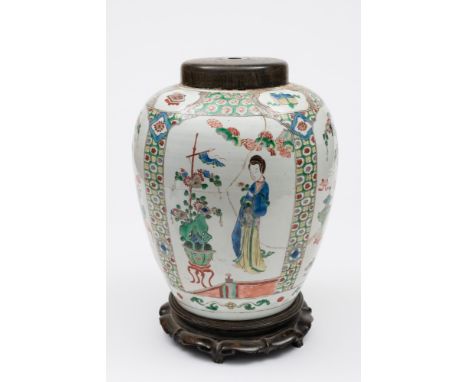 A Chinese famille verte jar: painted with shaped panels of court ladies on terraces and auspicious objects within foliate dia