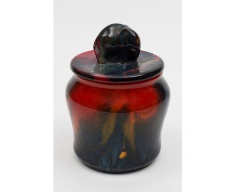 A Royal Doulton Flambe 'Sung' tobacco jar and cover:  with elephant finial, decorated overall with shades of red, blue, purpl