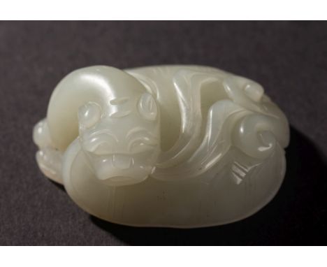 A Chinese celadon jade carving of a mythical turtle: its head leaning to one side, 5.5cm. long.

