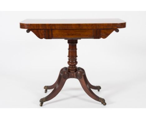 A Regency mahogany rectangular card table:, the baize lined hinged top with rounded corners, the frieze with bead ornament on