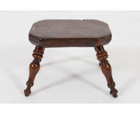 A late 18th/early 19th Century yew-wood stool:, of small size, the top with canted corners on turned and tapered splayed legs