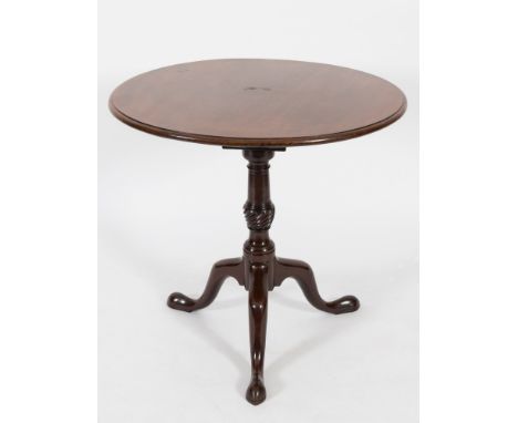 A mid 18th Century mahogany circular tea table:, the snap top with a moulded edge on ring turned and spirally fluted vase kno