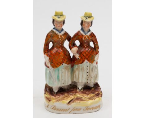 A Staffordshire portrait group of the 'Alphington Ponies': the Durnford sisters modelled arm in arm, wearing yellow bonnets a