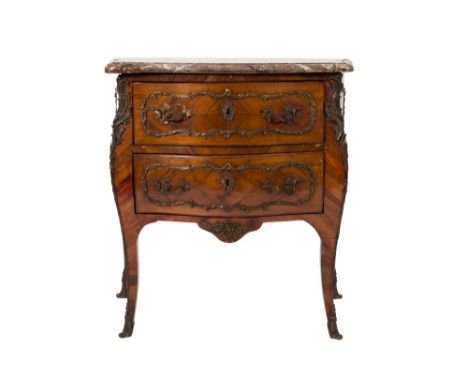 An early 19th Century French kingwood and gilt metal mounted serpentine fronted bombe commode in the Louis XV taste:, surmoun