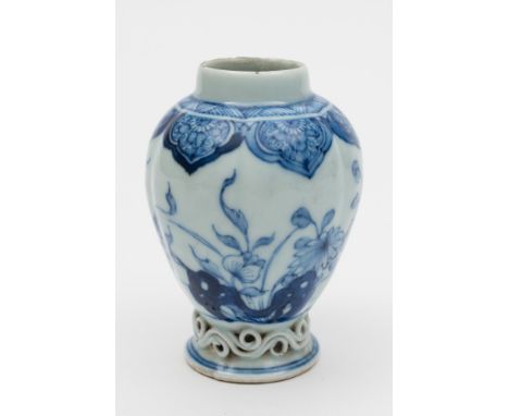 A Chinese porcelain tea canister: of lobed oviform with applied scroll moulded base, painted in blue with pierced rocks and p