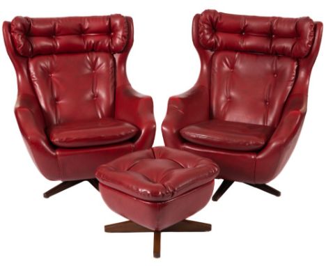 A pair of 1965  Parker Knoll Ambassador swivel and rocking armchairs and a matching stool:, upholstered in crimson buttoned f
