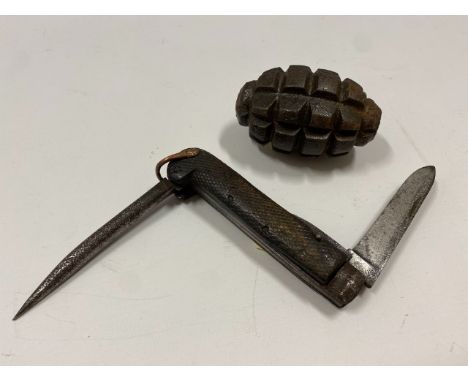 A WW2 hand grenade twinned with an antique army pocket knife