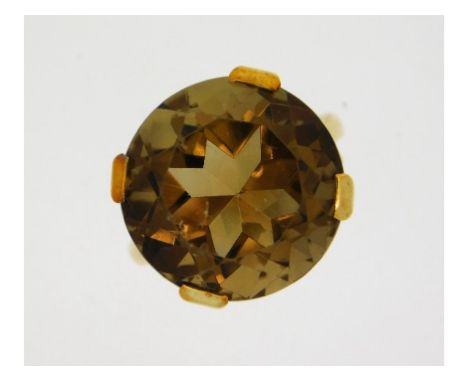 A 9ct gold smokey quartz ring, small chips to edge of table, stone 23mm diameter, size N/M, 8.09g