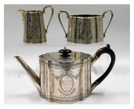 A three piece 19thC. silver tea service by Walter &amp; John Barnard with chased decor &amp; inscription, presented to Rev. A