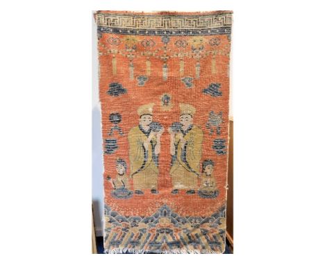 An 18thC. Sino-Tibetan woollen temple pillar rug depicting figures with conch shells, the ancient lungs of Buddha, above a wo