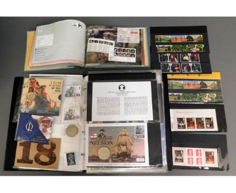 A collection of commemorative coin covers including £5 covers, two mint £10 stamps &amp; a small collection of presentation p