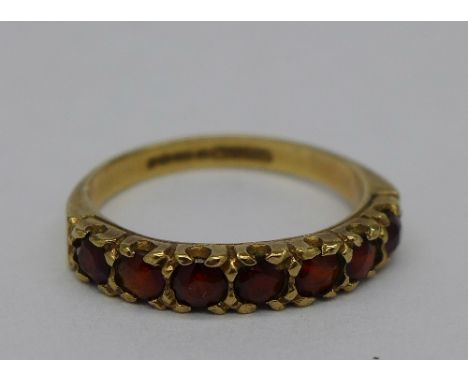 A 9ct gold and seven stone garnet ring, weight 2.2g, size N