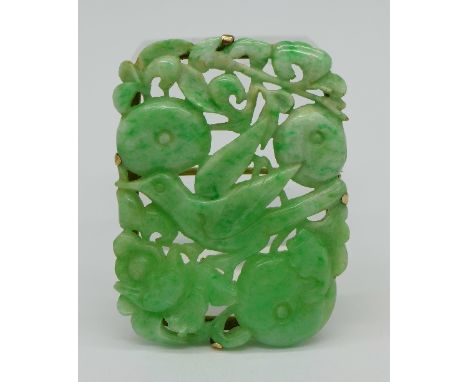 A carved jade brooch, 44mm x 32mm
