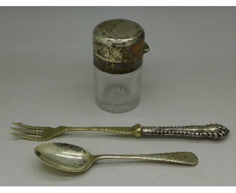 A silver topped salts jar, lacking inner stopper, a silver spoon and a silver handled pickle fork