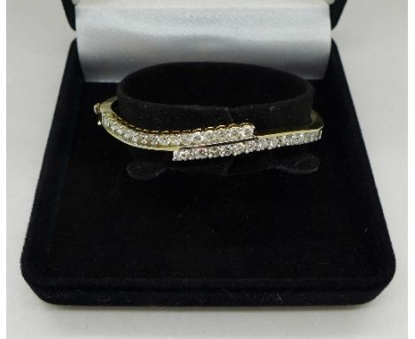 A 14ct gold and diamond bangle, over 3 carat total diamond weight, weight 14.8g