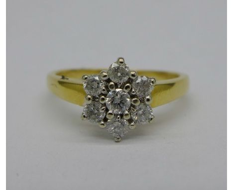 An 18ct gold and diamond cluster ring, 0.5 carat diamond weight, 3.1g, M