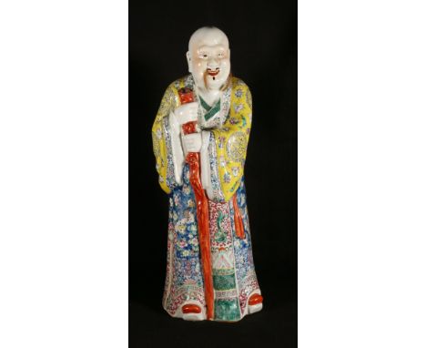 Large Chinese famille rose porcelain figure of an immortal holding a staff, seal mark to base, 60cm CONDITION REPORT: Staff t