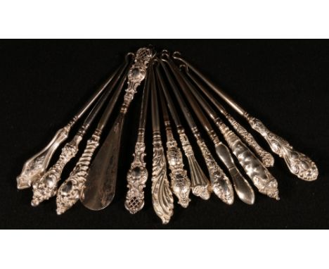 Collection of eleven smaller button hooks with embossed silver handles and another with pierced end and matching shoe horn