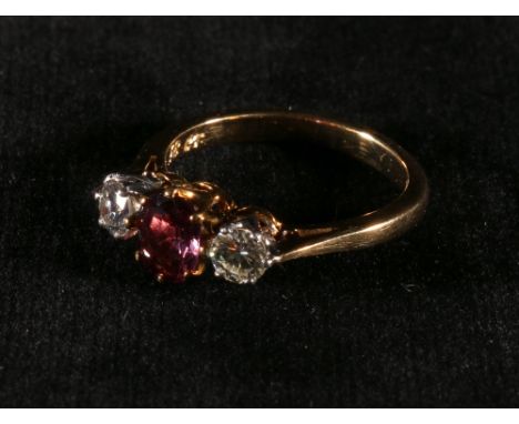 Diamond and ruby (uncertificated) three stone ring in gold '18ct' CONDITION REPORT: Gemstones are clean but not overly bright