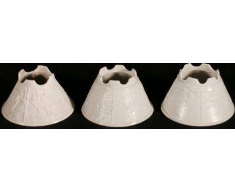 Three lithophane tea light holders of conical form one depicting castles, the other two depicting garden scenes with figures,