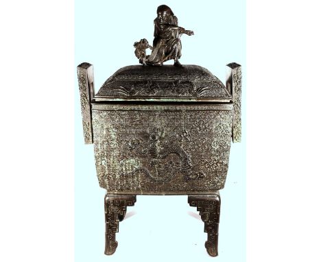 Japanese massive box container and cover with straight pierced rectangular handles and elaborate finial in the form of a man 
