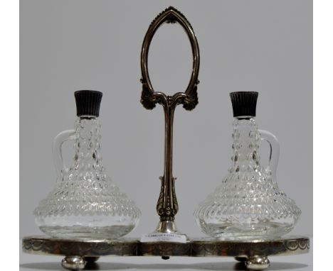 AN ORNATE ART NOUVEAU EPNS DECANTER STAND WITH PAIR OF DECANTERS WITH STOPPERS     