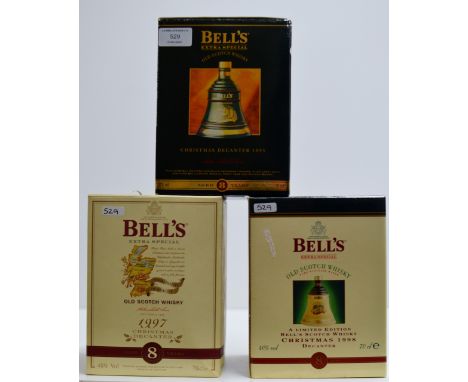 A GROUP OF 3 BELL'S CHRISTMAS WHISKY DECANTERS WITH PRESENTATION BOXES - EACH DECANTER = 70CL, 40% VOL     