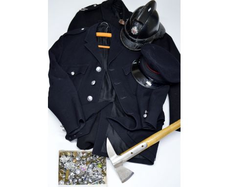 A VINTAGE FIREMAN'S UNIFORM WITH A JACKET, AN OVERCOAT, A HELMET, A HAT, AN AXE &amp; VARIOUS BADGES     
