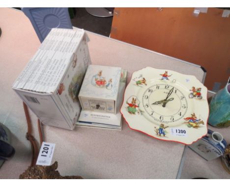 A Beatrix Potter Royal Winton "Bunny's Playtime" ceramic wall clock, plus "The Peter Rabbit Library", 12 volume set in card s