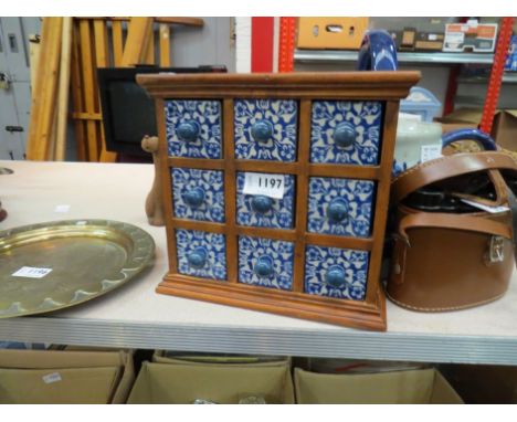 A hardwood spice box with nine blue and white ceramic drawers, 22cm tall x 22cm wide