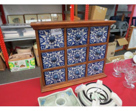 A hardwood spice box with nine blue and white ceramic drawers, 28cm tall x 32cm wide